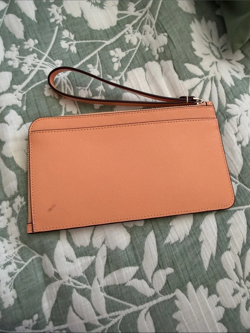 kate spade peach/orange leather wristlet with gold logo